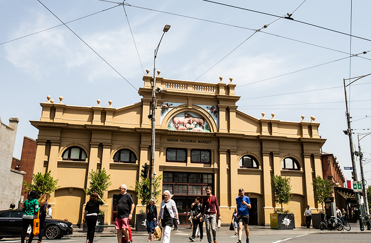 The facade of the Queen Vic Market drenched in sunlight.